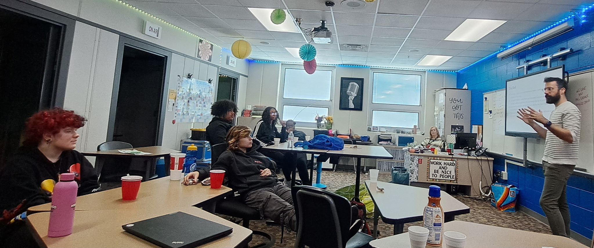 Nick Hrkman leads a journalism workshop with Dayton-area high school students in a classroom, with students seated at tables listening attentively
